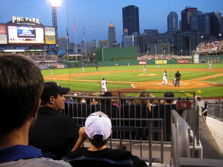 people watching the baseball game on a field