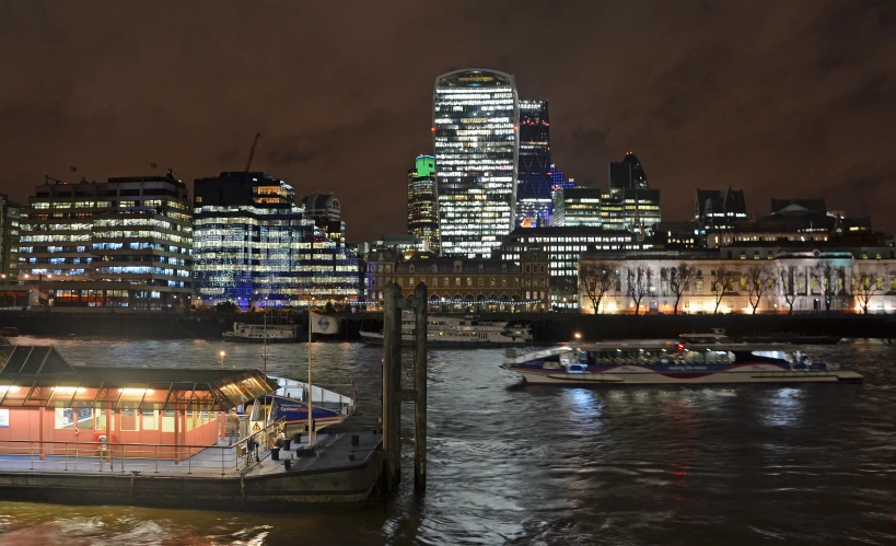 a city that is lit up and very near the water