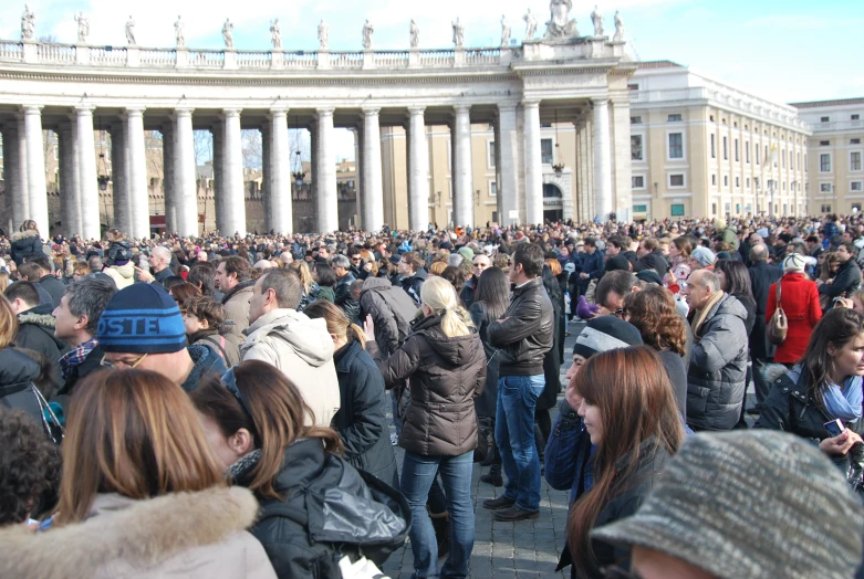 a crowd of people gather together at a public event