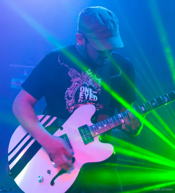 a guy with a guitar on stage playing