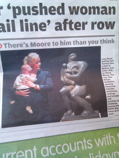 the newspaper article is being displayed with an image of woman holding her baby