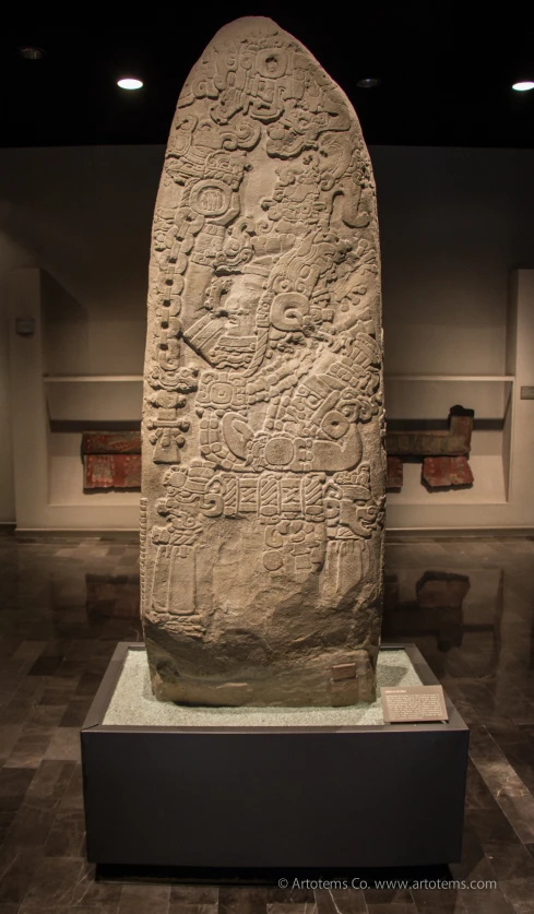 a very old stone object in a museum display
