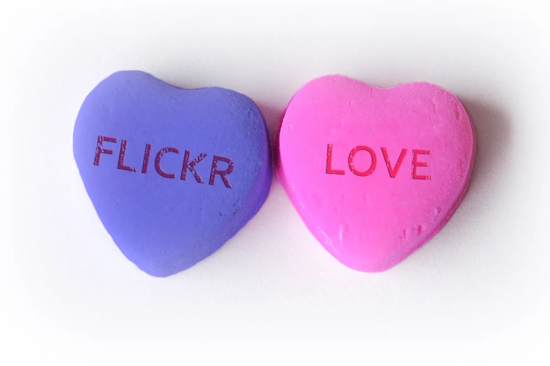 two heart candys one with the word flickr and the other with the word love