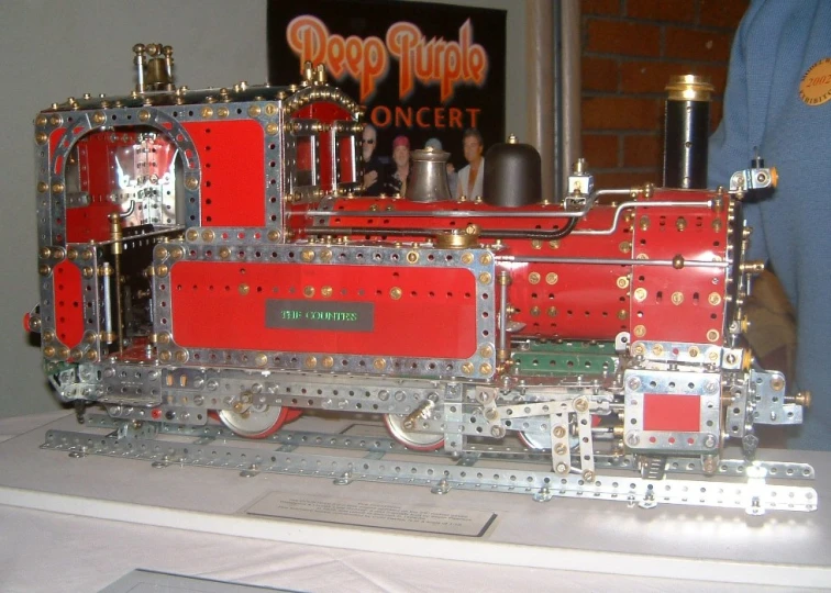 a silver and red toy train is on display