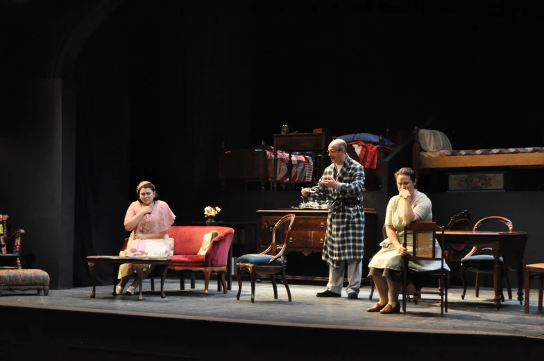 three actors sit on stage and talk