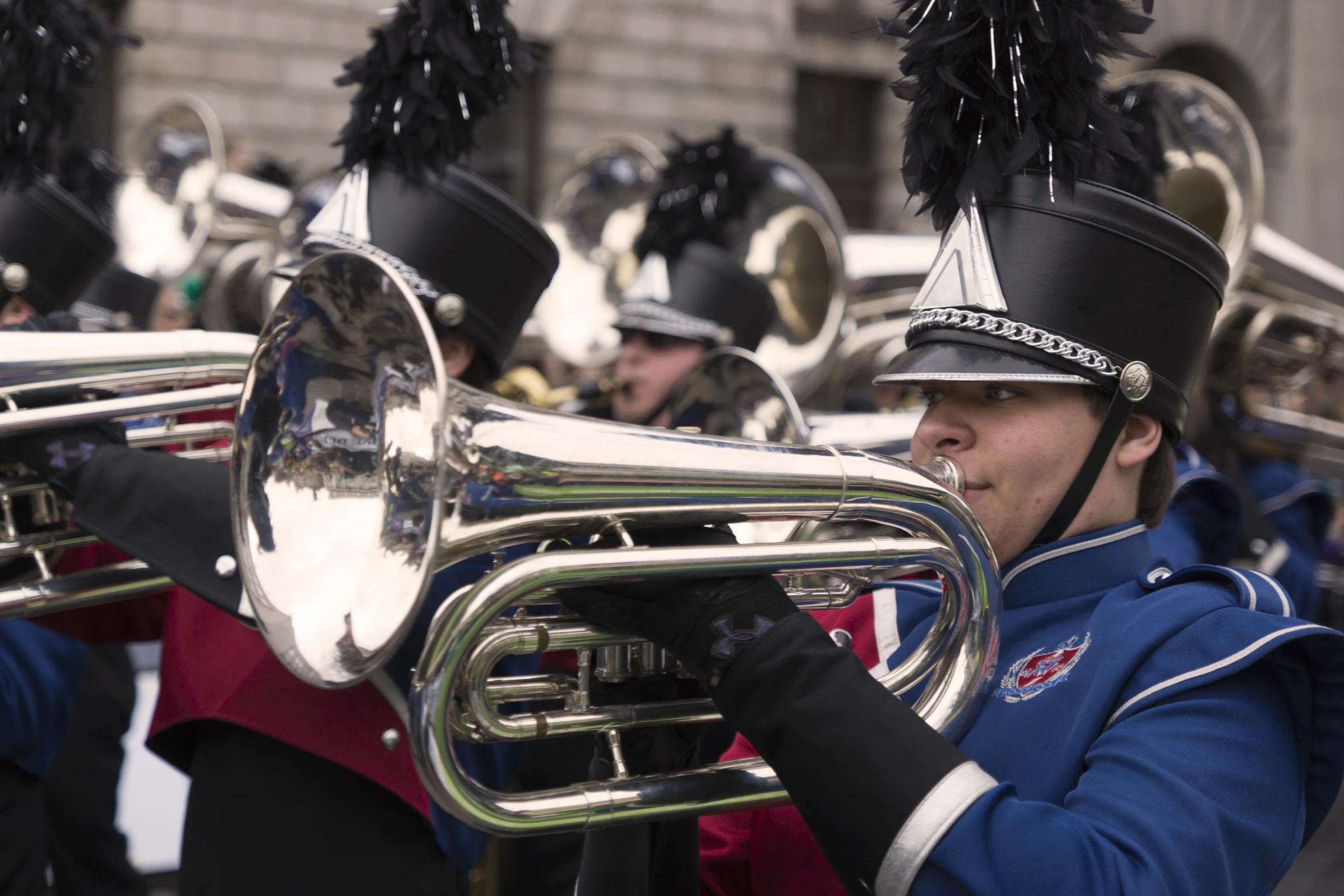 a marching band plays in front of a crowd