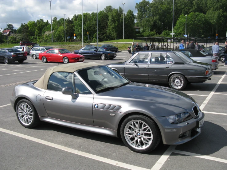 the silver convertible car is sitting in the lot