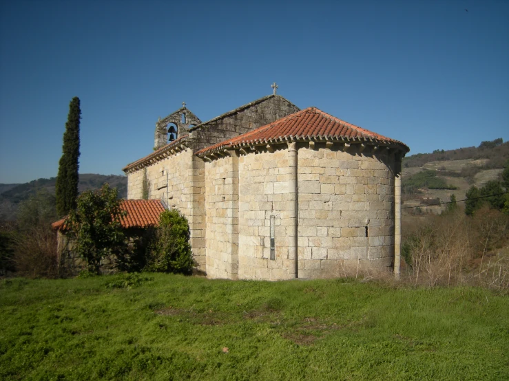 a building with orange tiled roof and window on top