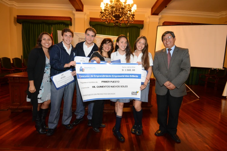 several people standing in front of a large check presentation