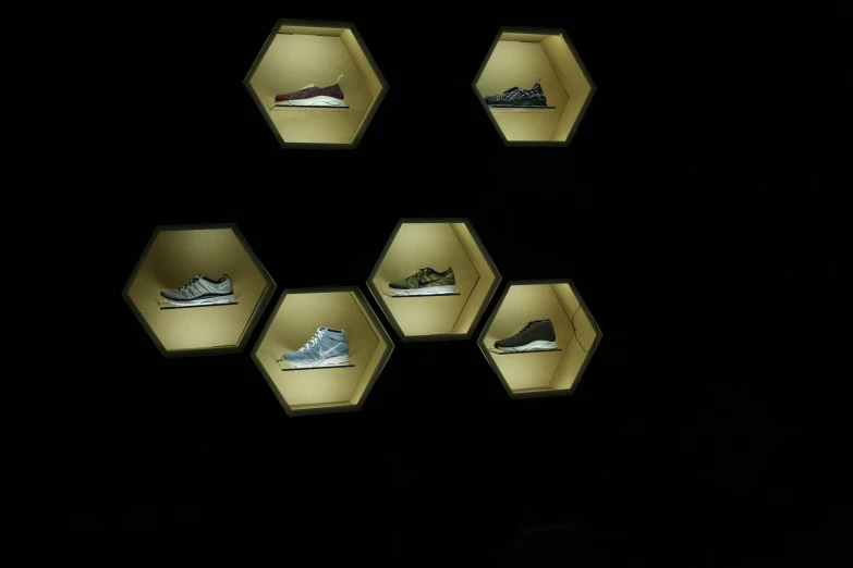 several different types of shoes displayed on illuminated cubes
