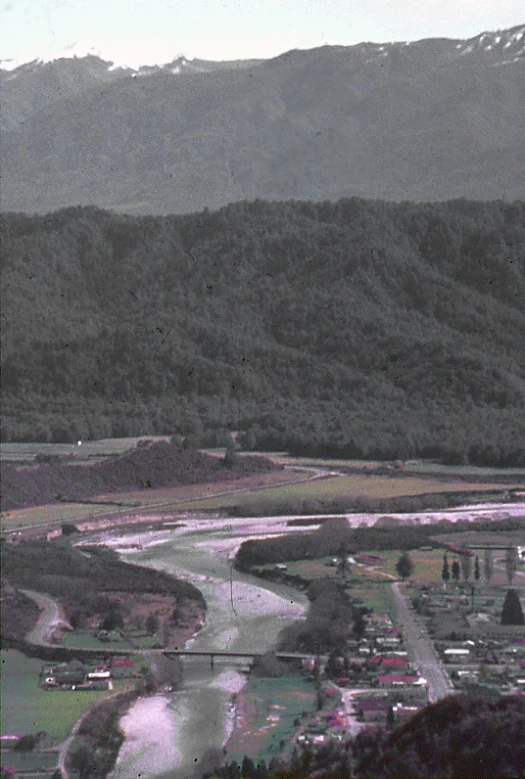 a panoramic s of a river surrounded by mountains