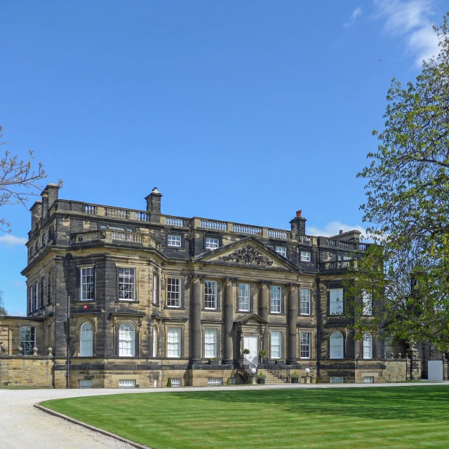 a large building that has some trees on the front