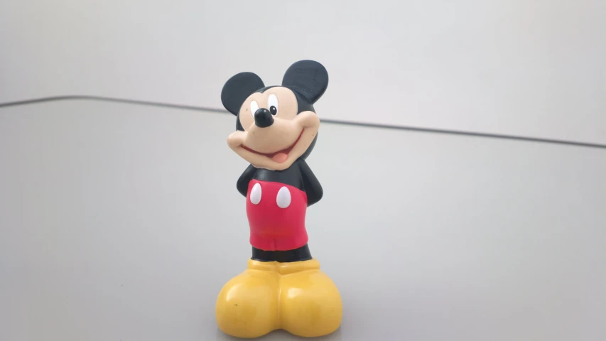 a toy mickey mouse sitting on the floor