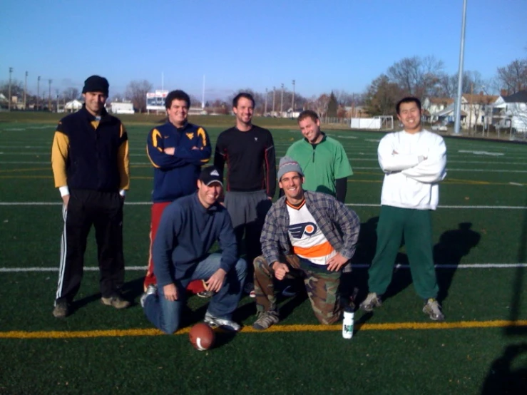 a group of men standing next to each other on a football field