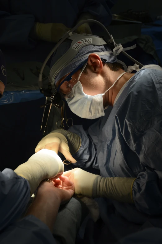 a close up of a person in a operating room with gloves on