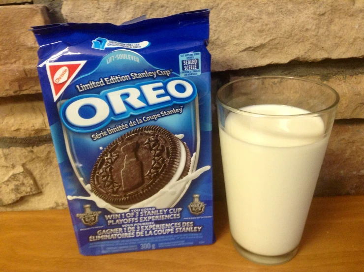 a package of oreo next to a glass of milk