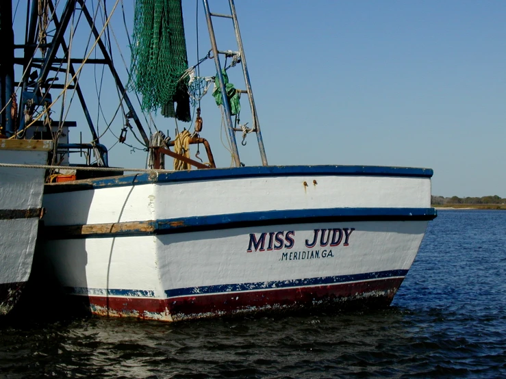 a small white boat in a body of water