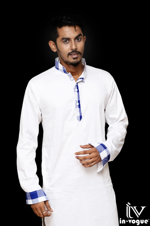 an indian man in white and blue clothes