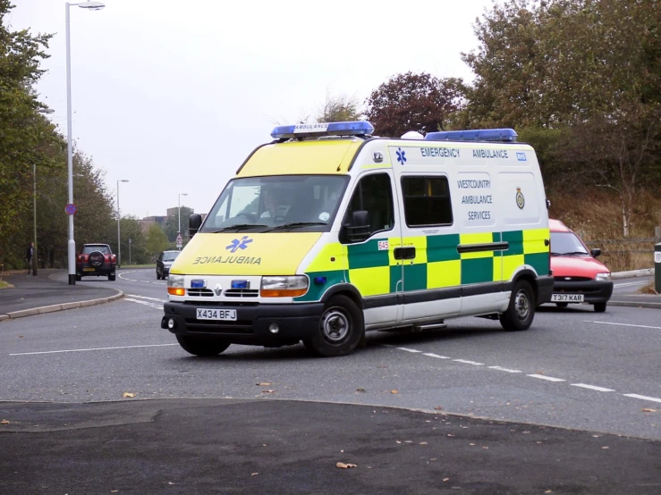 an ambulance with medical lights parked in front of another ambulance