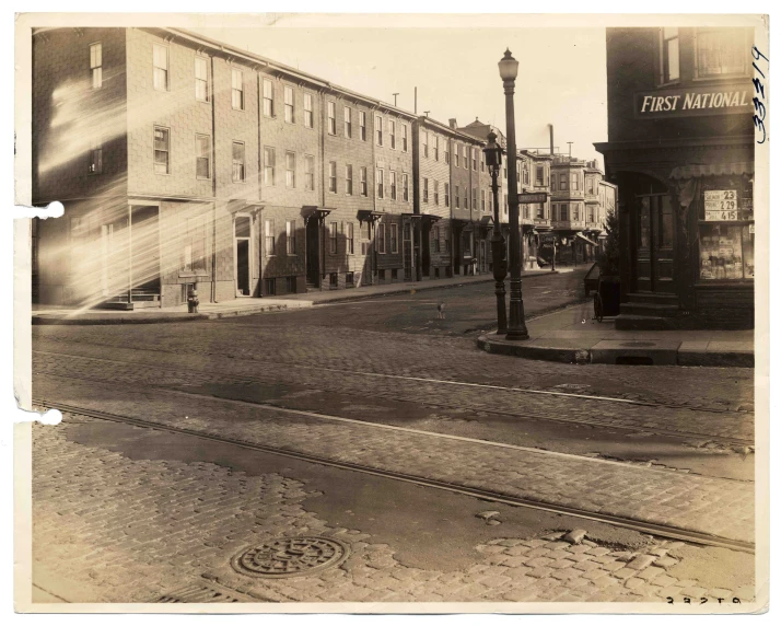 an old - fashioned po of a street in front of old buildings