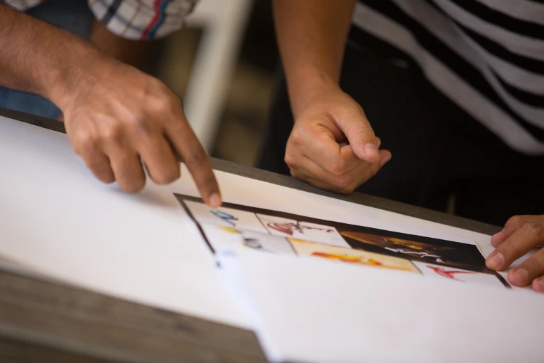 there is an image of a man with his hands on the table