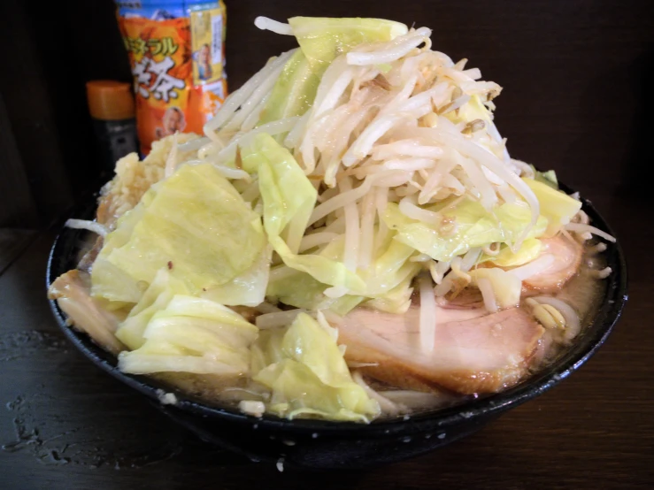 a bowl with meat, shredded cabbage and broth