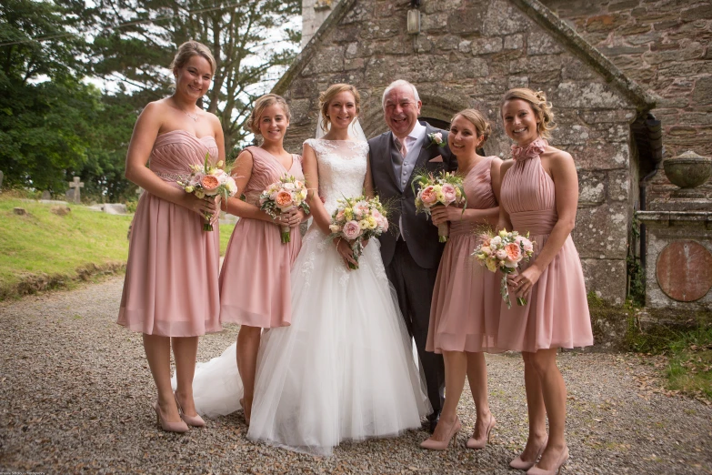 a family posing in front of an old stone building