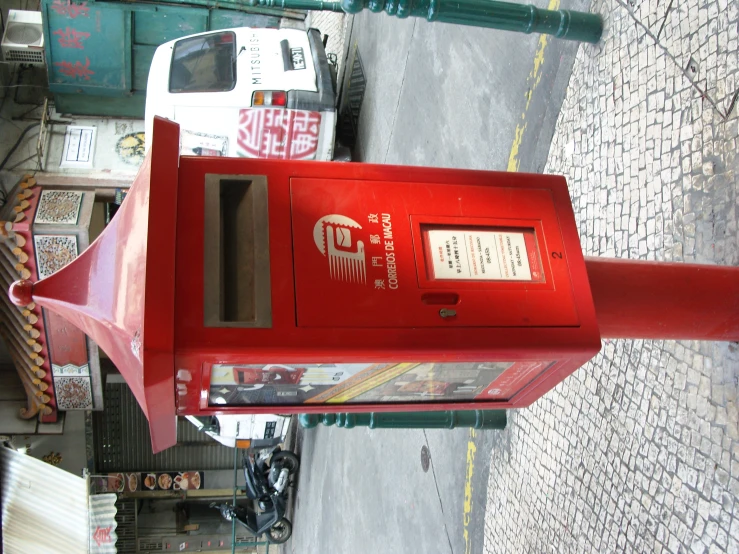 the red phone is sitting in the street