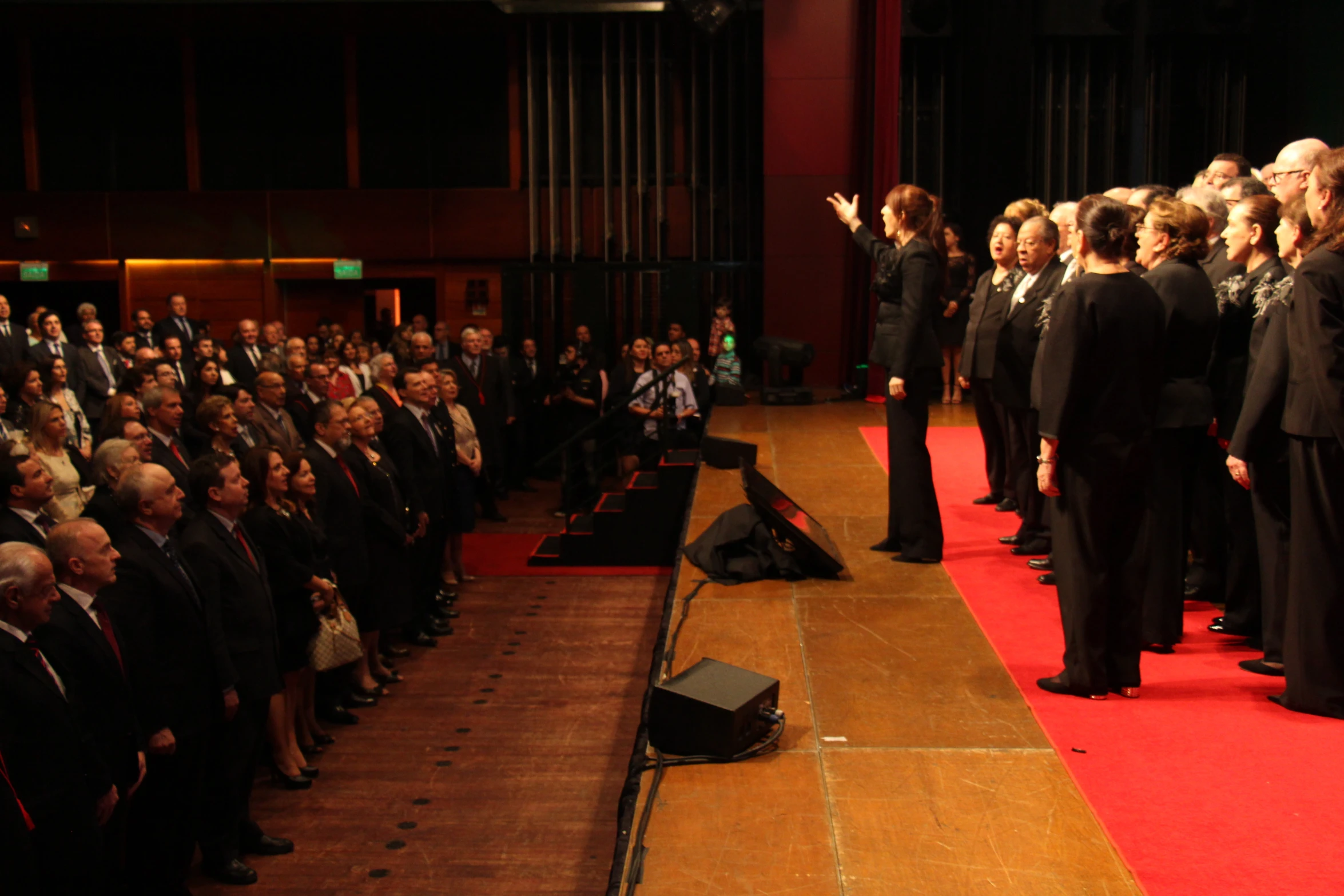 the audience watches a speaker on stage