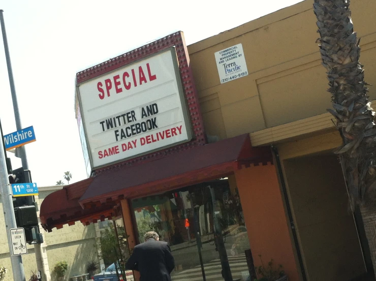 man in business attire walking past restaurant entrance