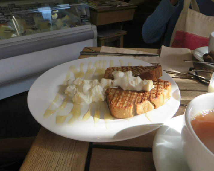 two waffles and a plate with whipped cream