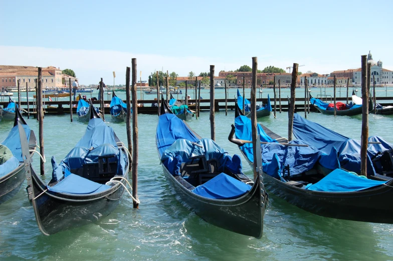 a view from a pier of a row of gondolas