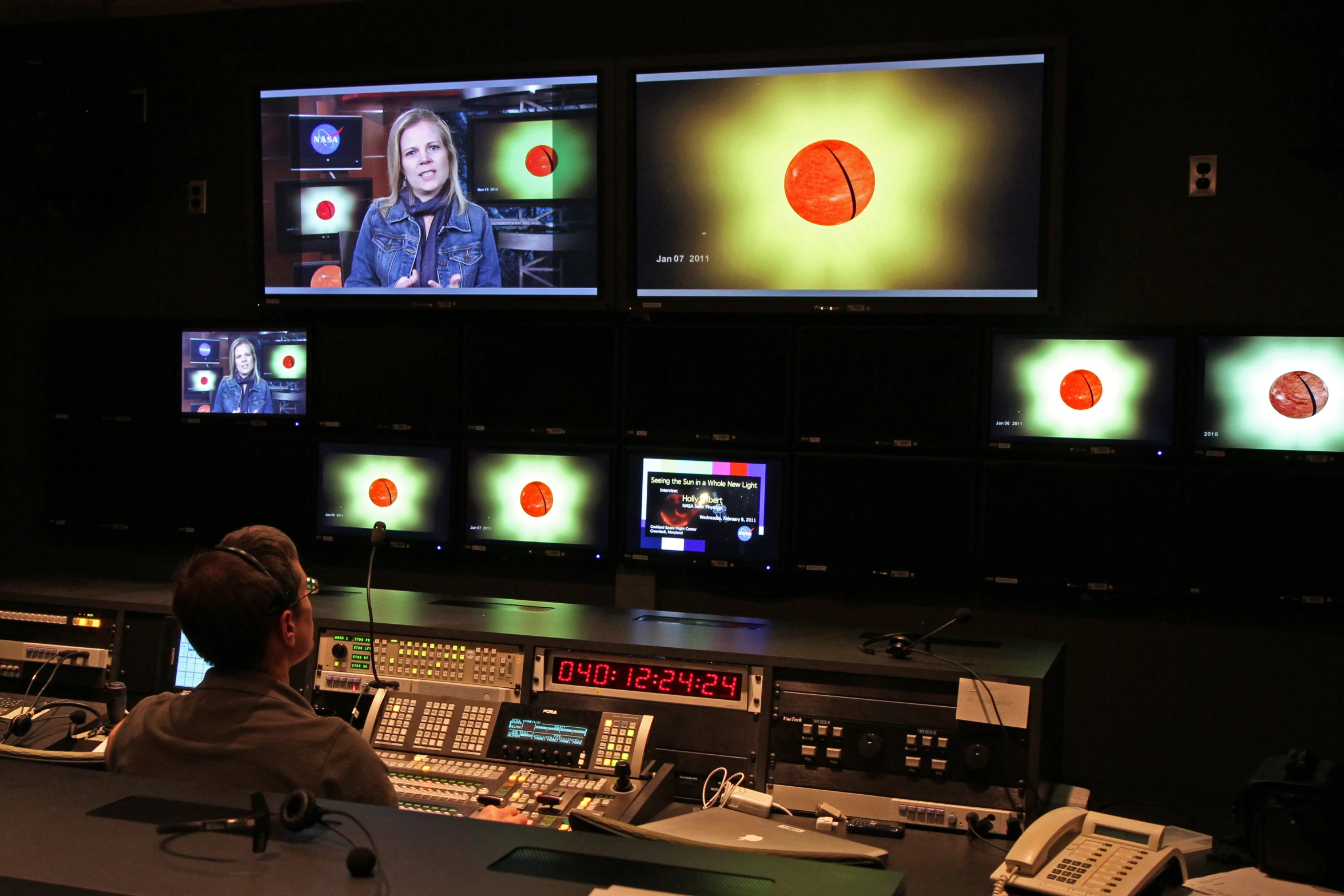 a control room with several monitors in front of it