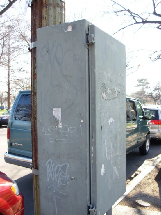 this is graffiti on an old refrigerator in the parking lot