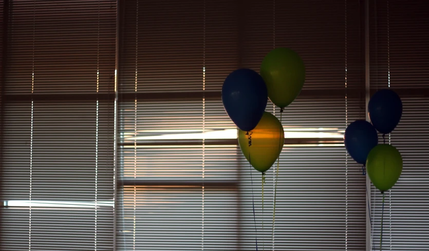 several balloons hanging from a ceiling in a room