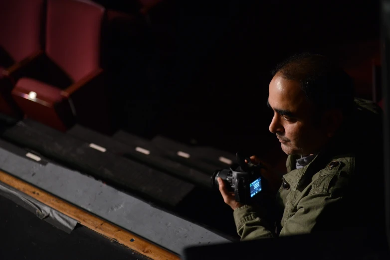 a man taking pictures of the seats in the theatre