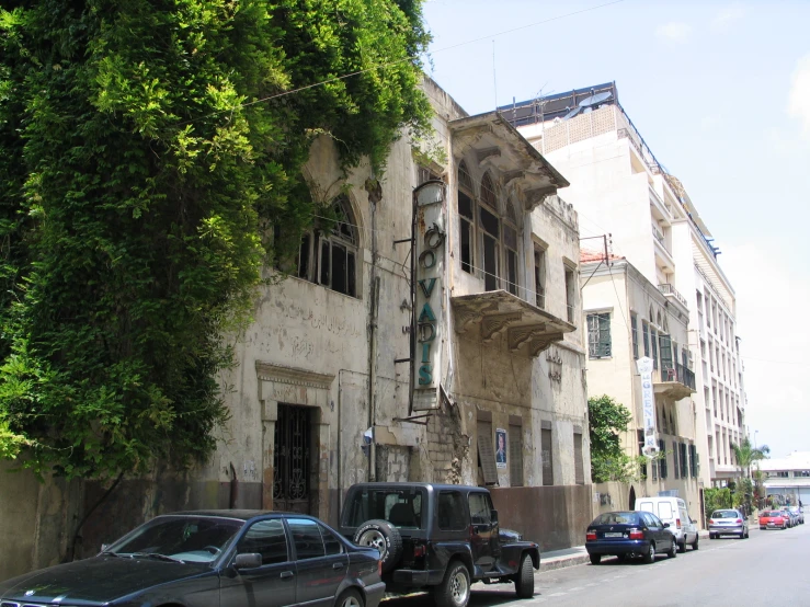 cars are parked on the street in front of a building