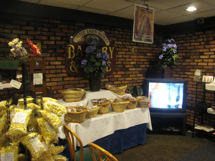 a table covered with bread and bowls next to a tv