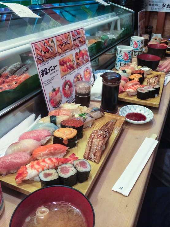an assortment of sushi and sashimi on a table