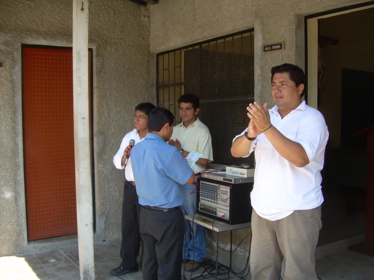 a few men standing around in front of a building