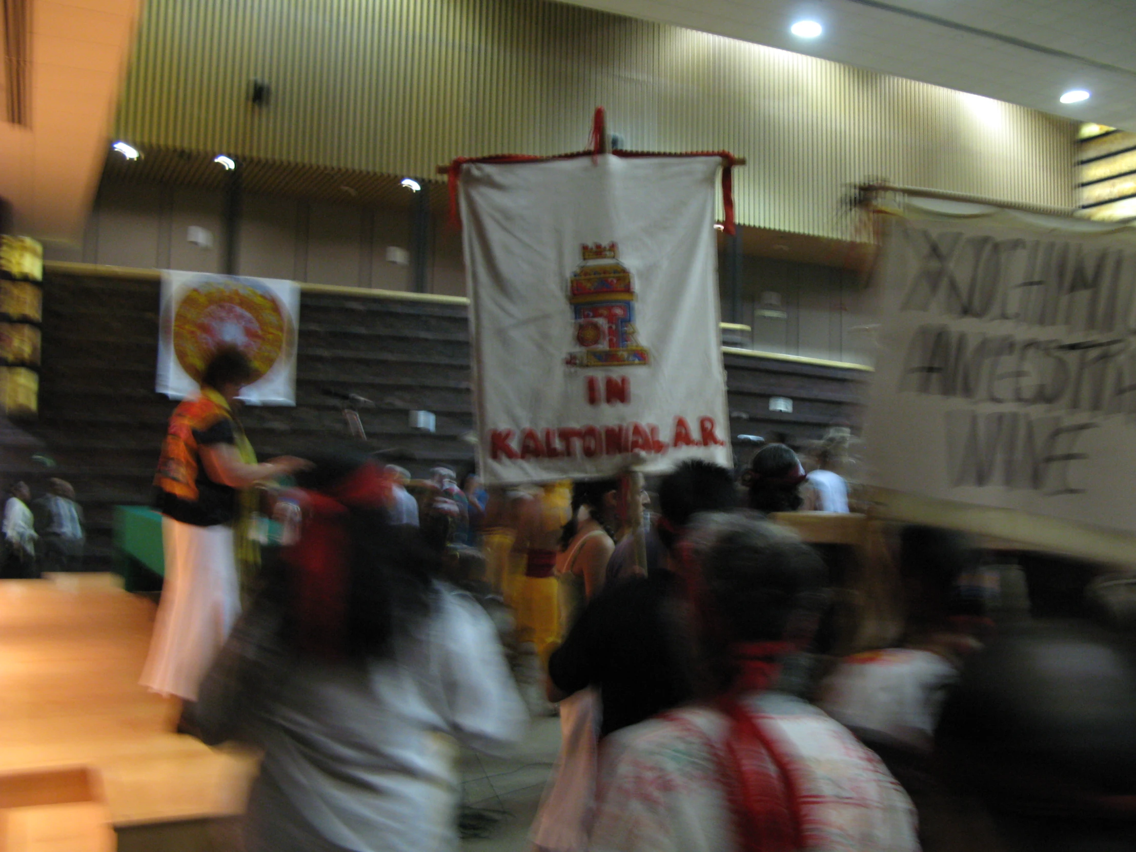 a group of people carrying a banner with an asian text