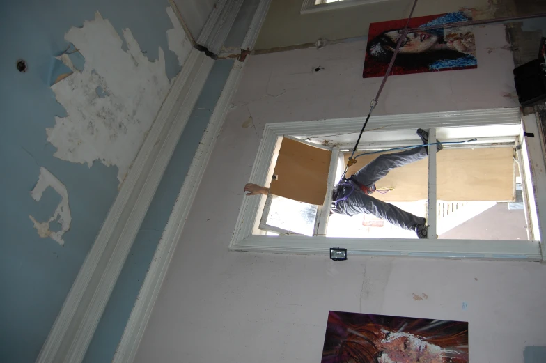 a man on a scaffolding lift in to an air duct leak