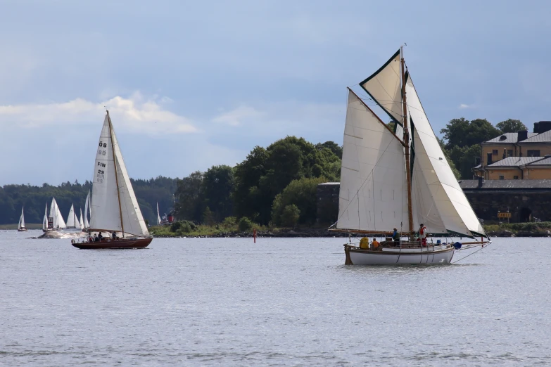 the sailboats are in motion on the water