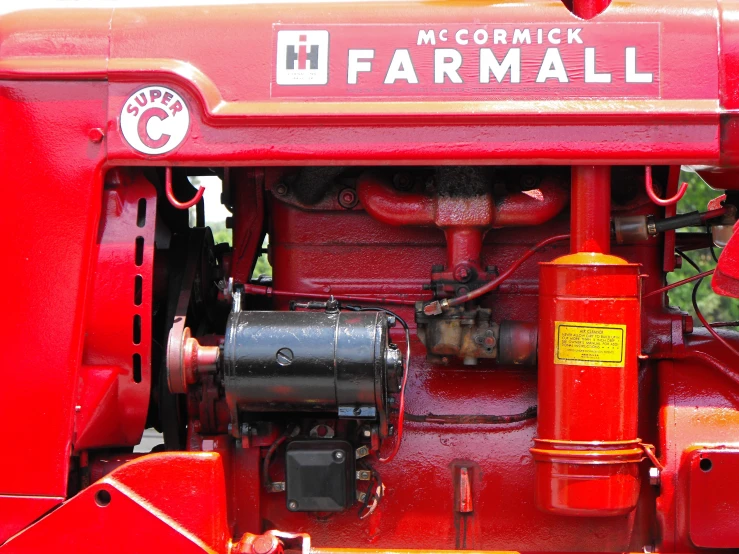 an old red farmall tractor with its door open