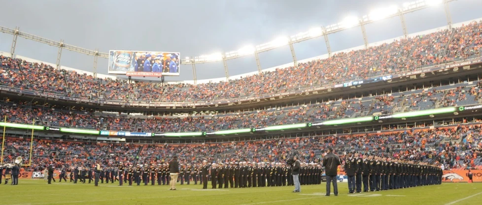 a group of people standing in front of an empty stadium