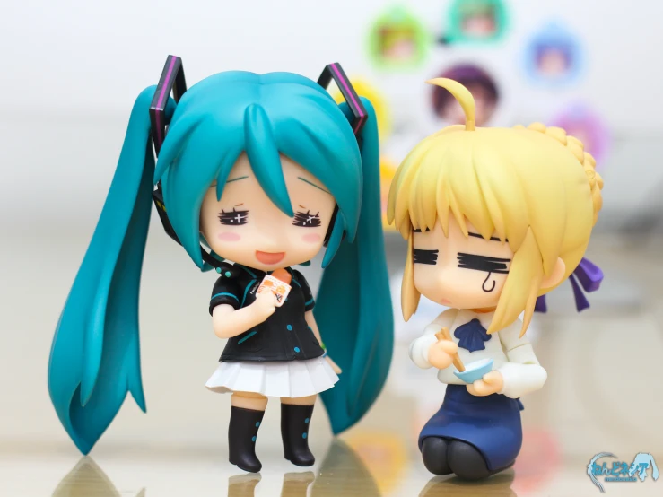 two small doll figurines are standing next to each other