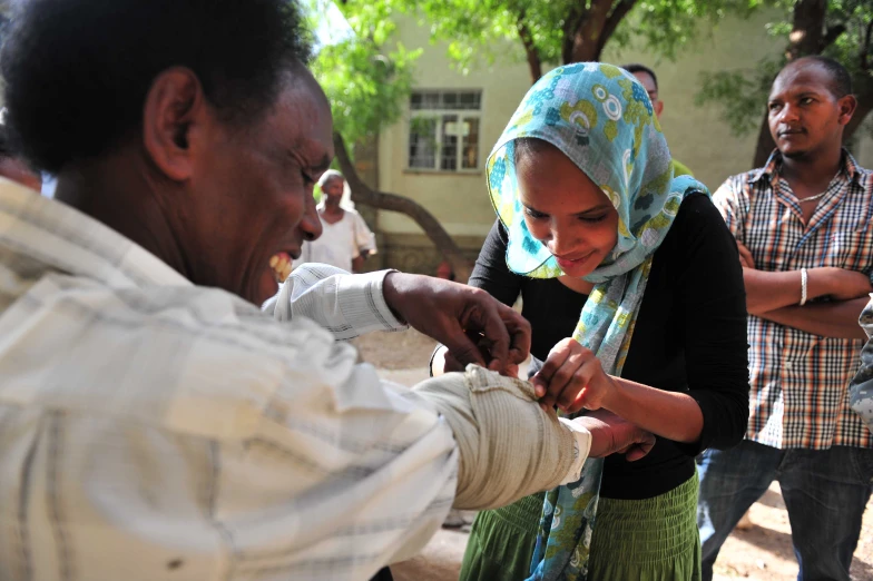 a woman is putting soing in her other hand