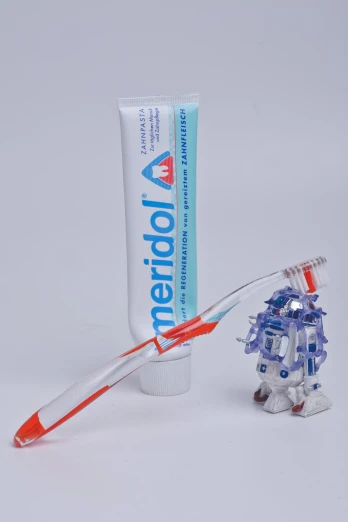 a toothbrush holder with toothpaste next to it