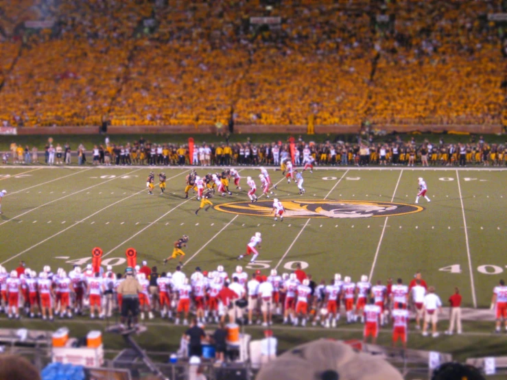 a football game is playing and fans are in the stands