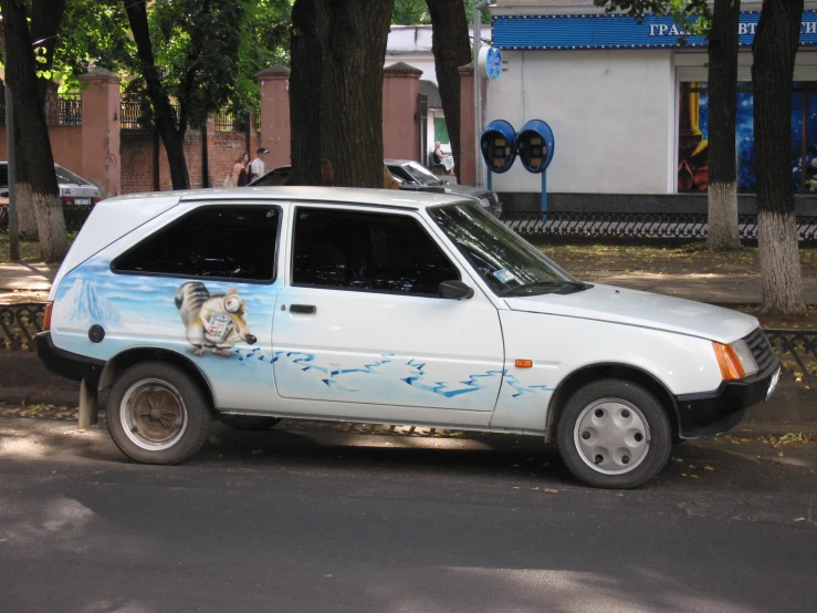 a parked car with a painted animal on the side